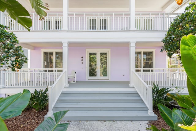 view of exterior entry with a porch