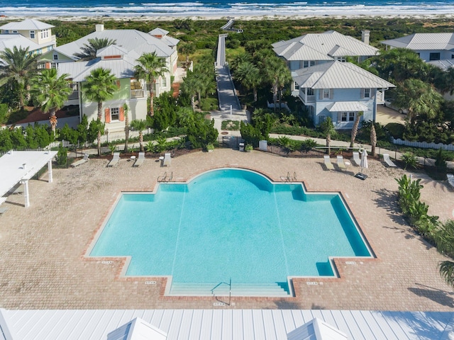 view of swimming pool featuring a patio area and a water view