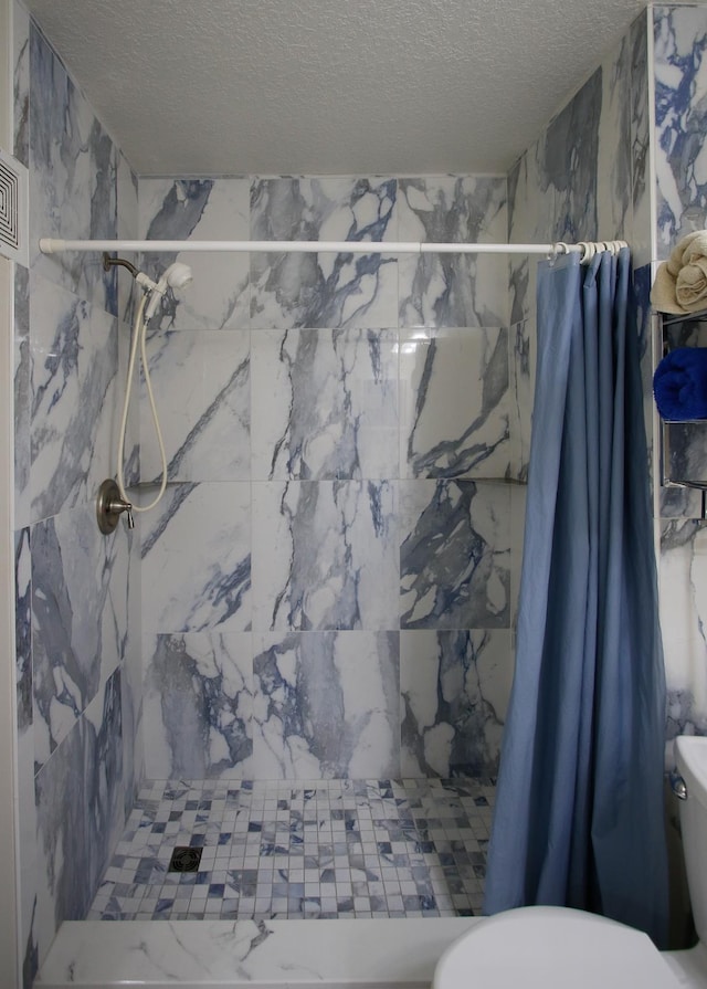 23213 Harbour Vista Cir, Saint Augustine, FL 32080 - full bathroom with a textured ceiling, a stall shower, and toilet