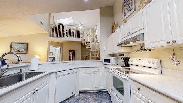 23213 Harbour Vista Cir, Saint Augustine, FL 32080 - kitchen with marble finish floor, white appliances, under cabinet range hood, white cabinets, and a sink