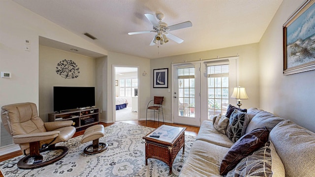 23213 Harbour Vista Cir, Saint Augustine, FL 32080 - living area featuring visible vents, lofted ceiling, wood finished floors, baseboards, and a ceiling fan
