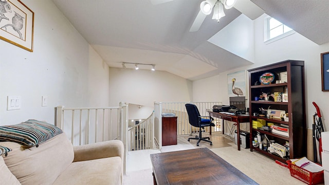 carpeted office space featuring vaulted ceiling, ceiling fan, and track lighting