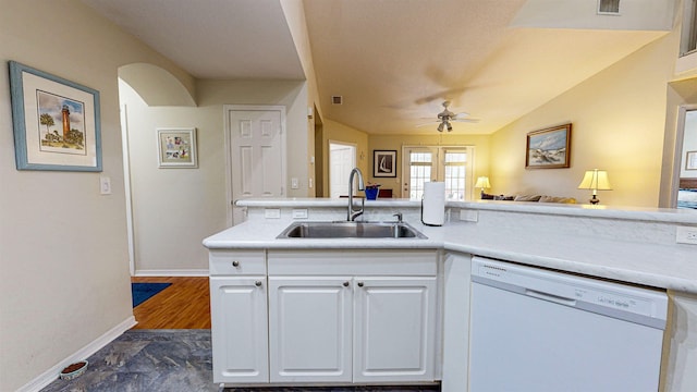 kitchen with white dishwasher, ceiling fan, sink, white cabinetry, and lofted ceiling