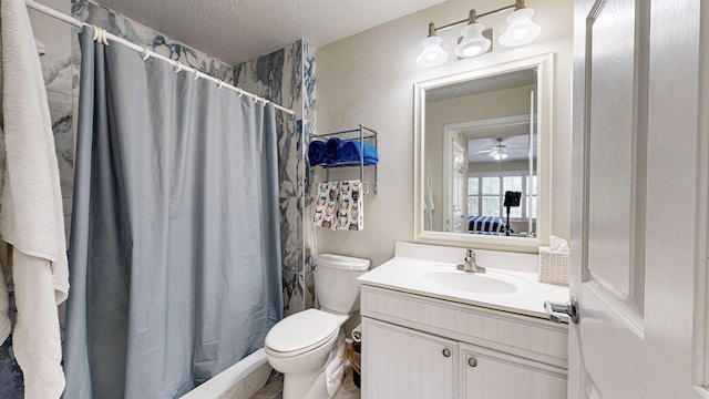 bathroom with vanity, ceiling fan, toilet, a textured ceiling, and walk in shower