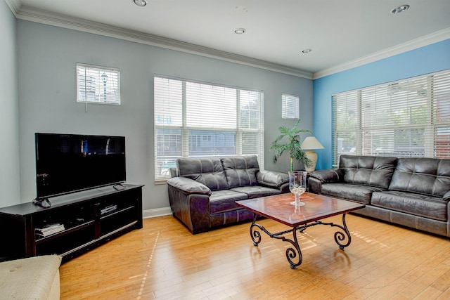 living room with plenty of natural light, ornamental molding, and light hardwood / wood-style flooring