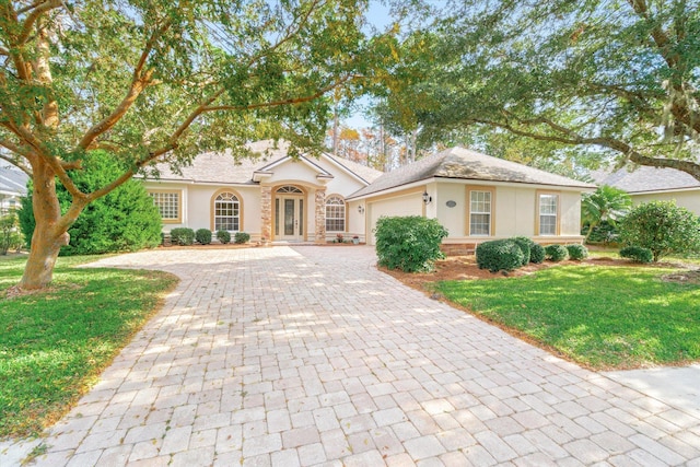 ranch-style home with a front yard and a garage