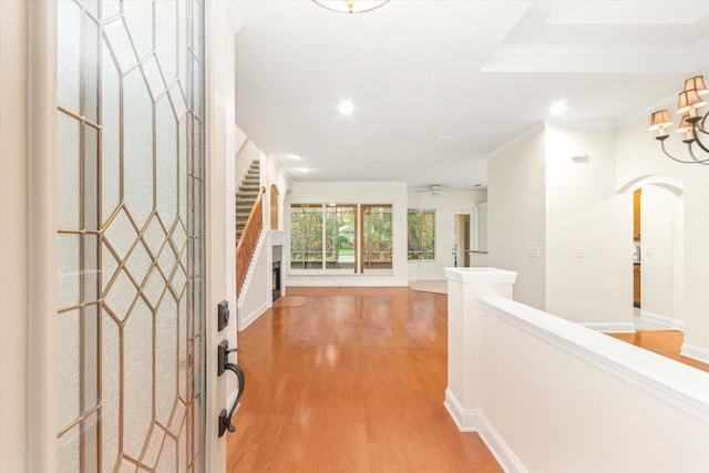 entrance foyer with light hardwood / wood-style flooring and ornamental molding