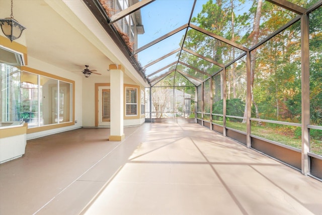 unfurnished sunroom with ceiling fan and lofted ceiling