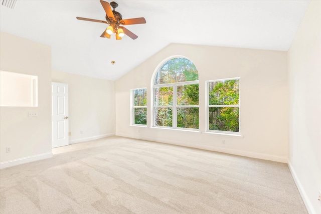 unfurnished room featuring light carpet, ceiling fan, and vaulted ceiling