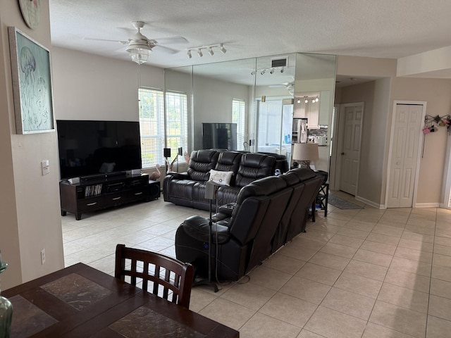 1810 Prestwick Pl, Saint Augustine, FL 32086 - living room featuring a ceiling fan, light tile patterned floors, a textured ceiling, and rail lighting