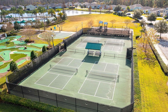 view of sport court with a water view