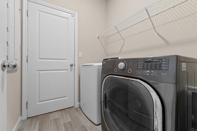 clothes washing area featuring washing machine and clothes dryer