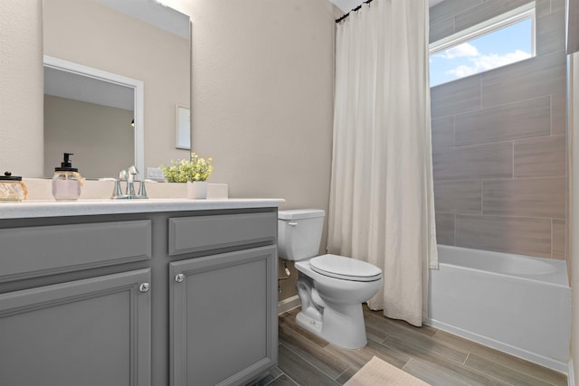 full bathroom with shower / tub combo with curtain, vanity, and toilet