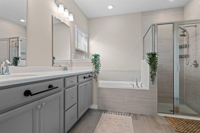 bathroom featuring vanity and independent shower and bath