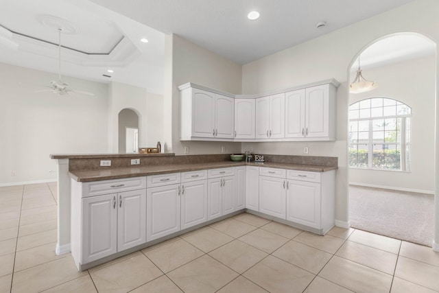 19 Ehrling Ln, Palm Coast, FL 32164 - kitchen featuring arched walkways, ceiling fan, recessed lighting, baseboards, and white cabinets