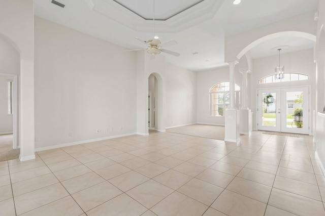 19 Ehrling Ln, Palm Coast, FL 32164 - spare room with arched walkways, light tile patterned flooring, decorative columns, a towering ceiling, and a ceiling fan