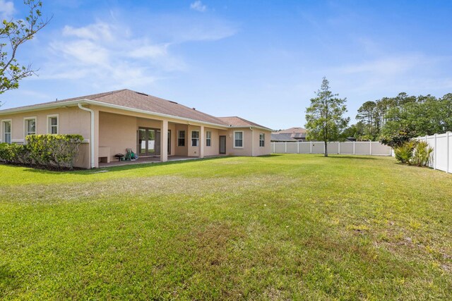 19 Ehrling Ln, Palm Coast, FL 32164 - back of house featuring stucco siding