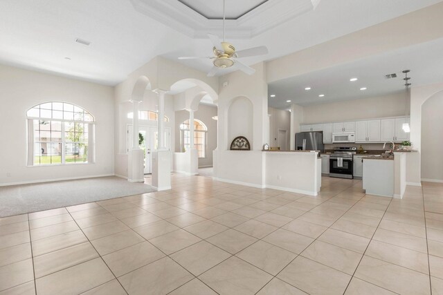 19 Ehrling Ln, Palm Coast, FL 32164 - unfurnished living room featuring plenty of natural light, light tile patterned floors, arched walkways, a ceiling fan, and recessed lighting