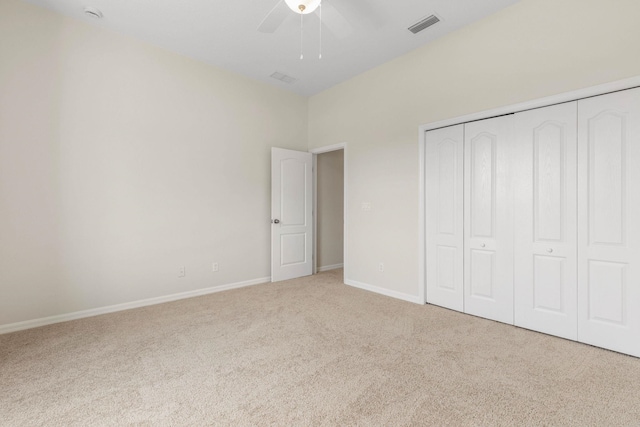 19 Ehrling Ln, Palm Coast, FL 32164 - unfurnished bedroom with carpet flooring, a closet, baseboards, and a ceiling fan