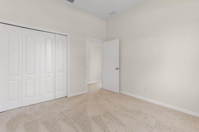 19 Ehrling Ln, Palm Coast, FL 32164 - unfurnished bedroom featuring carpet, a closet, and baseboards