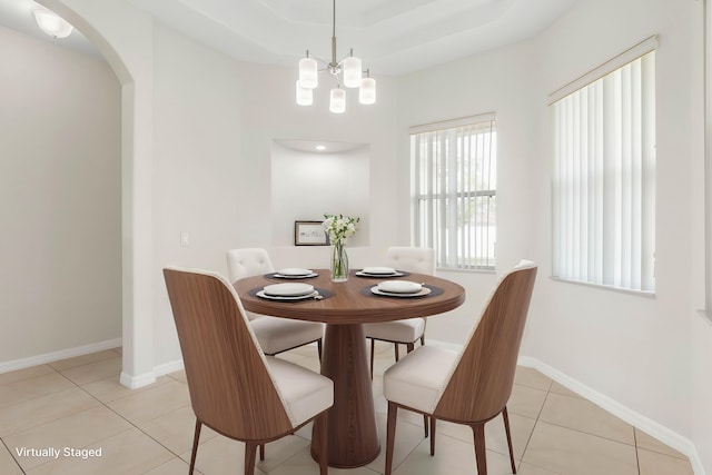 19 Ehrling Ln, Palm Coast, FL 32164 - dining space featuring light tile patterned flooring, arched walkways, a chandelier, and baseboards
