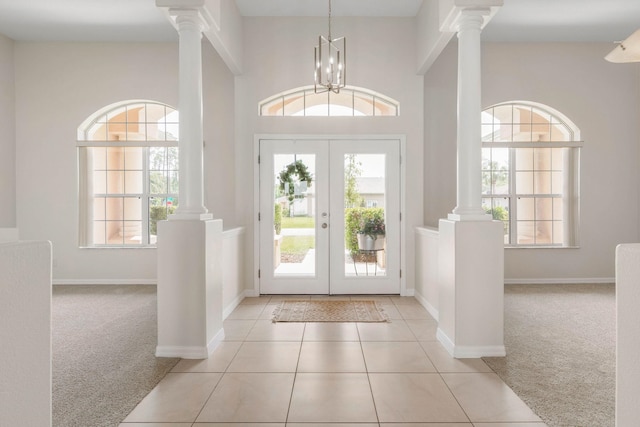 19 Ehrling Ln, Palm Coast, FL 32164 - tiled entrance foyer featuring carpet, ornate columns, french doors, and baseboards