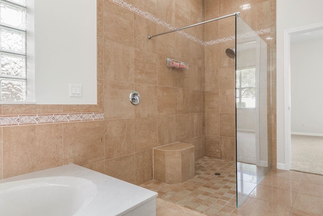 19 Ehrling Ln, Palm Coast, FL 32164 - bathroom with a tile shower, a bath, tile walls, and tile patterned floors