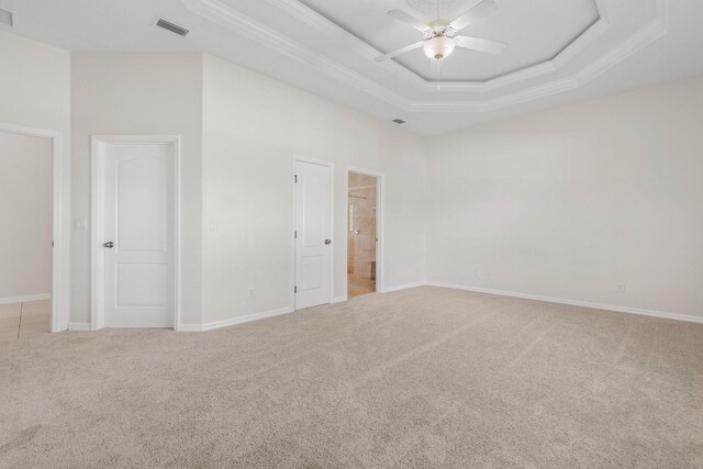 19 Ehrling Ln, Palm Coast, FL 32164 - spare room with carpet floors, crown molding, a ceiling fan, a tray ceiling, and baseboards