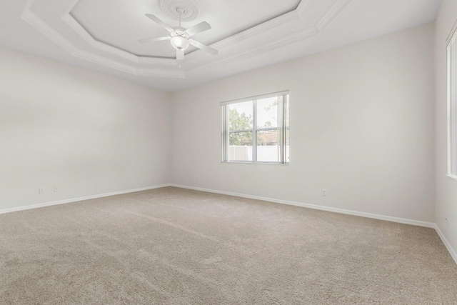 19 Ehrling Ln, Palm Coast, FL 32164 - carpeted empty room featuring a ceiling fan, a raised ceiling, crown molding, and baseboards