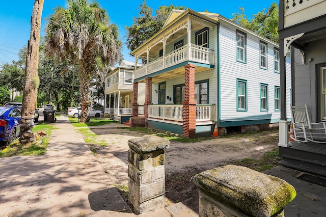 view of side of home featuring covered porch