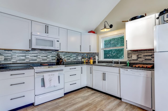 kitchen with white cabinetry, lofted ceiling, sink, white appliances, and light hardwood / wood-style flooring