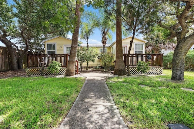 view of front of property with a wooden deck and a front yard