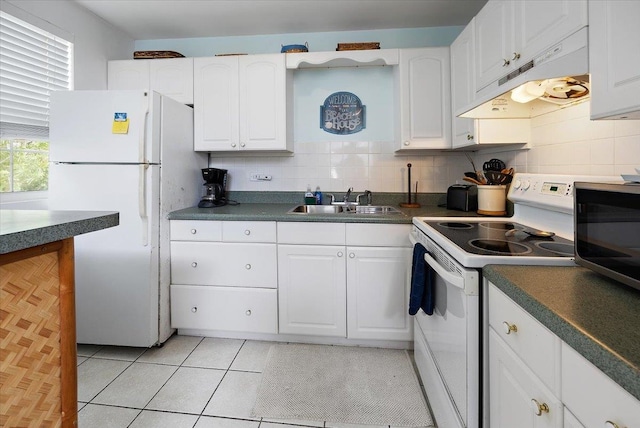 kitchen with sink, light tile patterned floors, backsplash, white appliances, and white cabinets