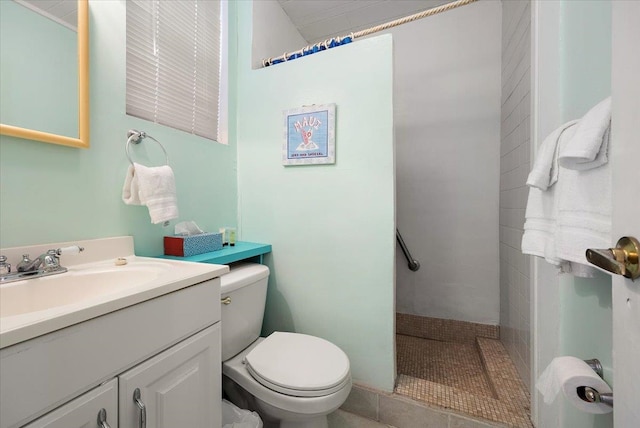 bathroom featuring tile patterned floors, vanity, and toilet