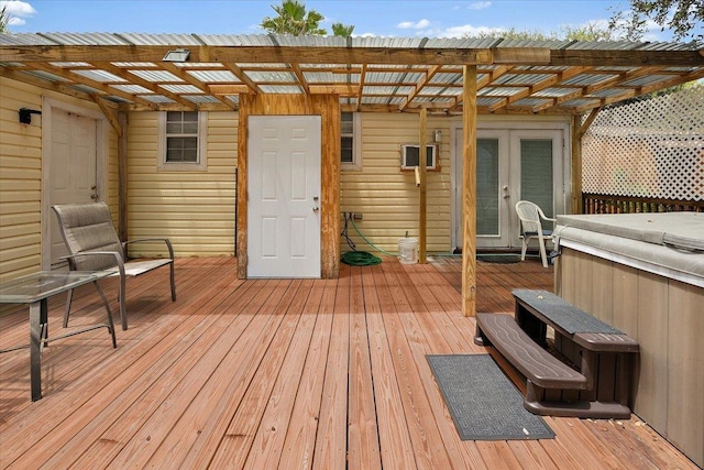 deck featuring a pergola, french doors, and a hot tub