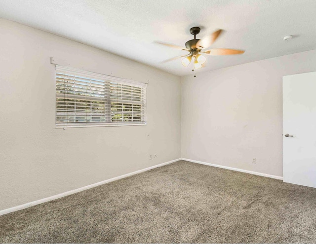 carpeted empty room featuring ceiling fan and a textured ceiling