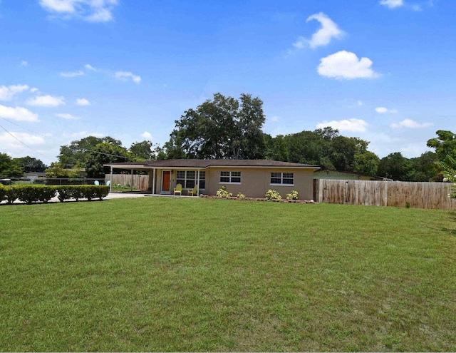 exterior space featuring a carport and a front lawn