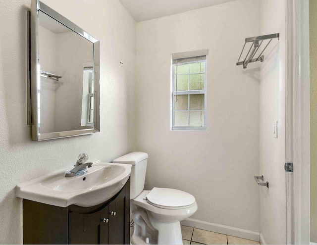 bathroom with tile patterned floors, vanity, and toilet