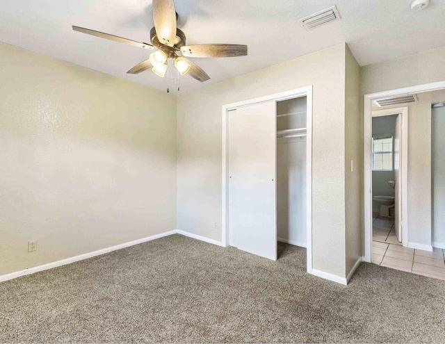 unfurnished bedroom with carpet floors, a closet, and ceiling fan