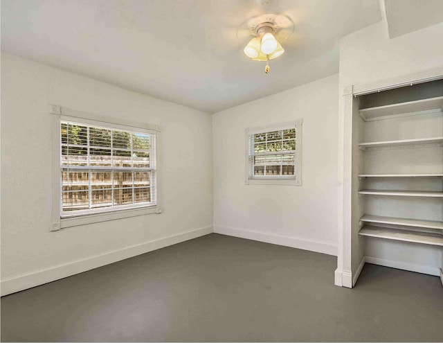 unfurnished bedroom with ceiling fan and multiple windows