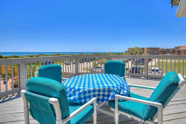 wooden terrace featuring a water view