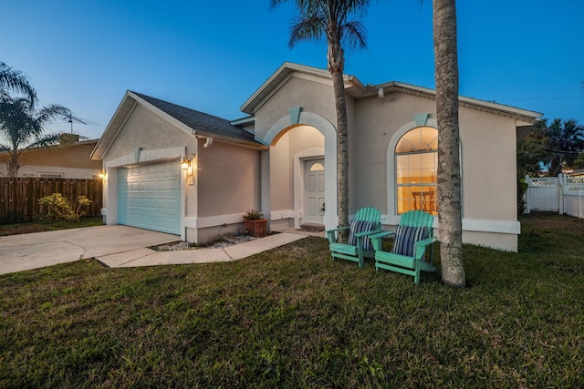 view of front of home featuring a yard and a garage