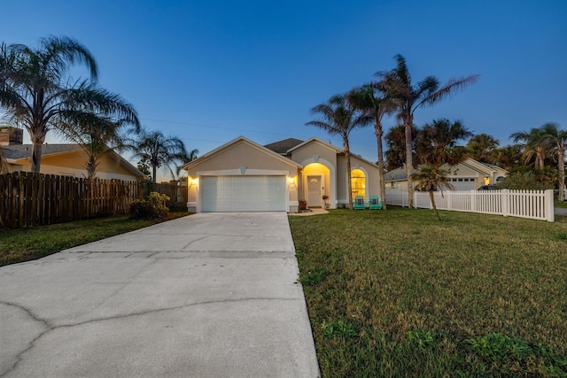 single story home with a lawn and a garage