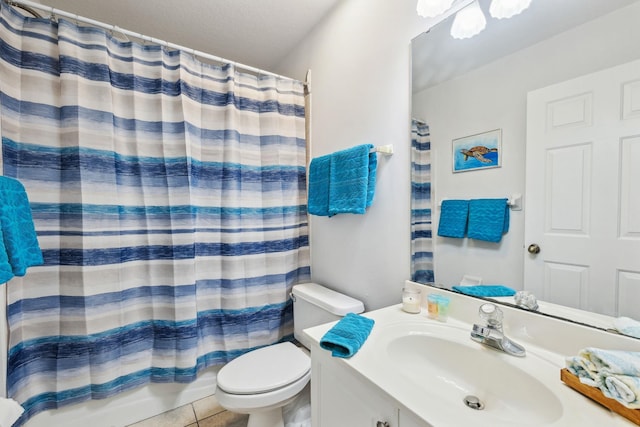 bathroom with toilet, tile patterned floors, and vanity