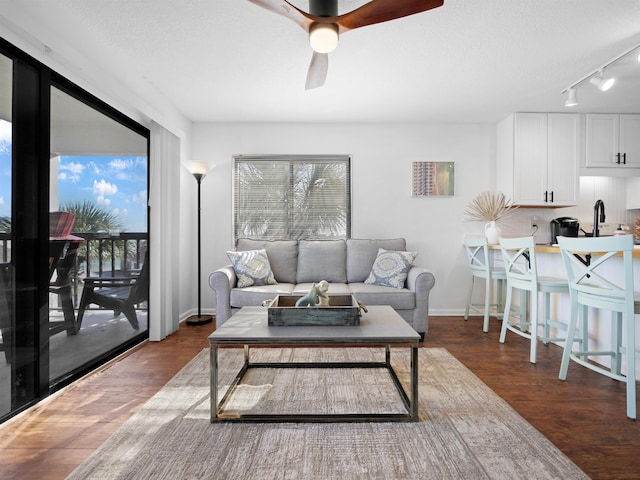 4250 S A1A Unit D33, Saint Augustine, FL 32080 - living room with ceiling fan, rail lighting, wood finished floors, and baseboards