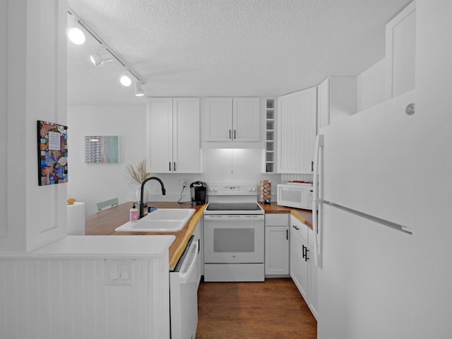 4250 S A1A Unit D33, Saint Augustine, FL 32080 - kitchen with white appliances, a sink, a textured ceiling, white cabinetry, and dark wood-type flooring
