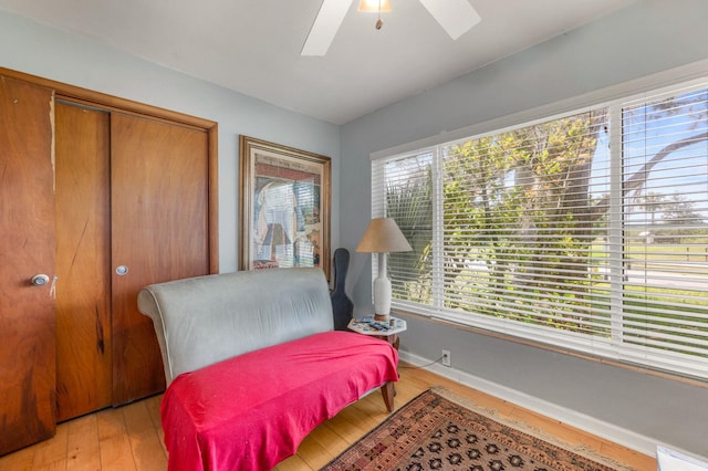 sitting room featuring ceiling fan, a healthy amount of sunlight, and light hardwood / wood-style floors