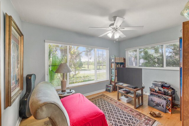 sitting room with light hardwood / wood-style flooring and ceiling fan