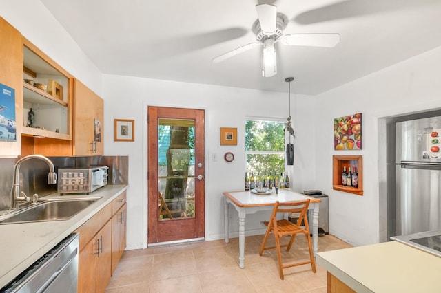 kitchen featuring breakfast area, hanging light fixtures, sink, light tile patterned floors, and appliances with stainless steel finishes