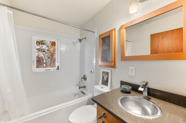 full bathroom featuring vanity, toilet, and shower / tub combo